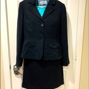 Tahari Business suit. Size12. Navy with pinstripe. Jacket and skirt. Gently used